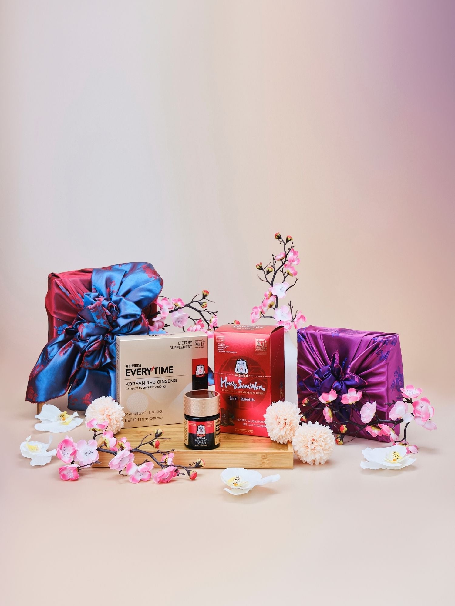 Lunar New Year Korean red ginseng immune gift set featuring Everytime 2000mg sticks, Hong Sam Won, and 120g extract jar wrapped in traditional Korean bojagi with flowers