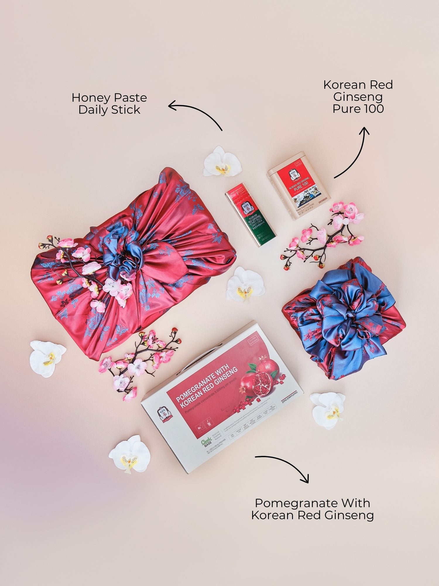 Lunar New Year Vitality Gift Set featuring pomegranate with Korean red ginseng, Pure 100 extract, and honey paste daily sticks displayed with a teapot, lantern and flowers
